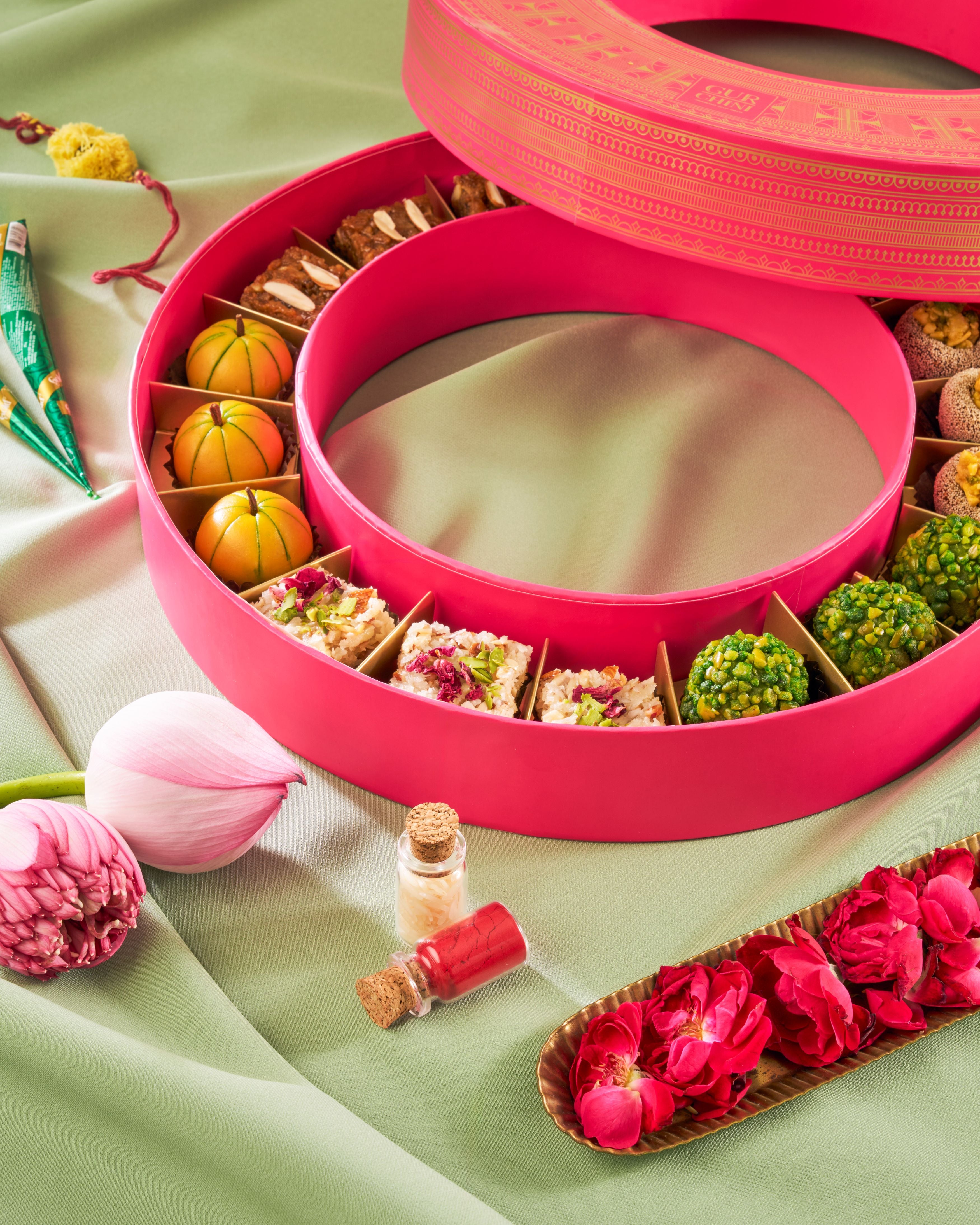 Rakhi Celebration Luxury Pink - Magenta Round Assorted Sweets Box of 18 Pcs