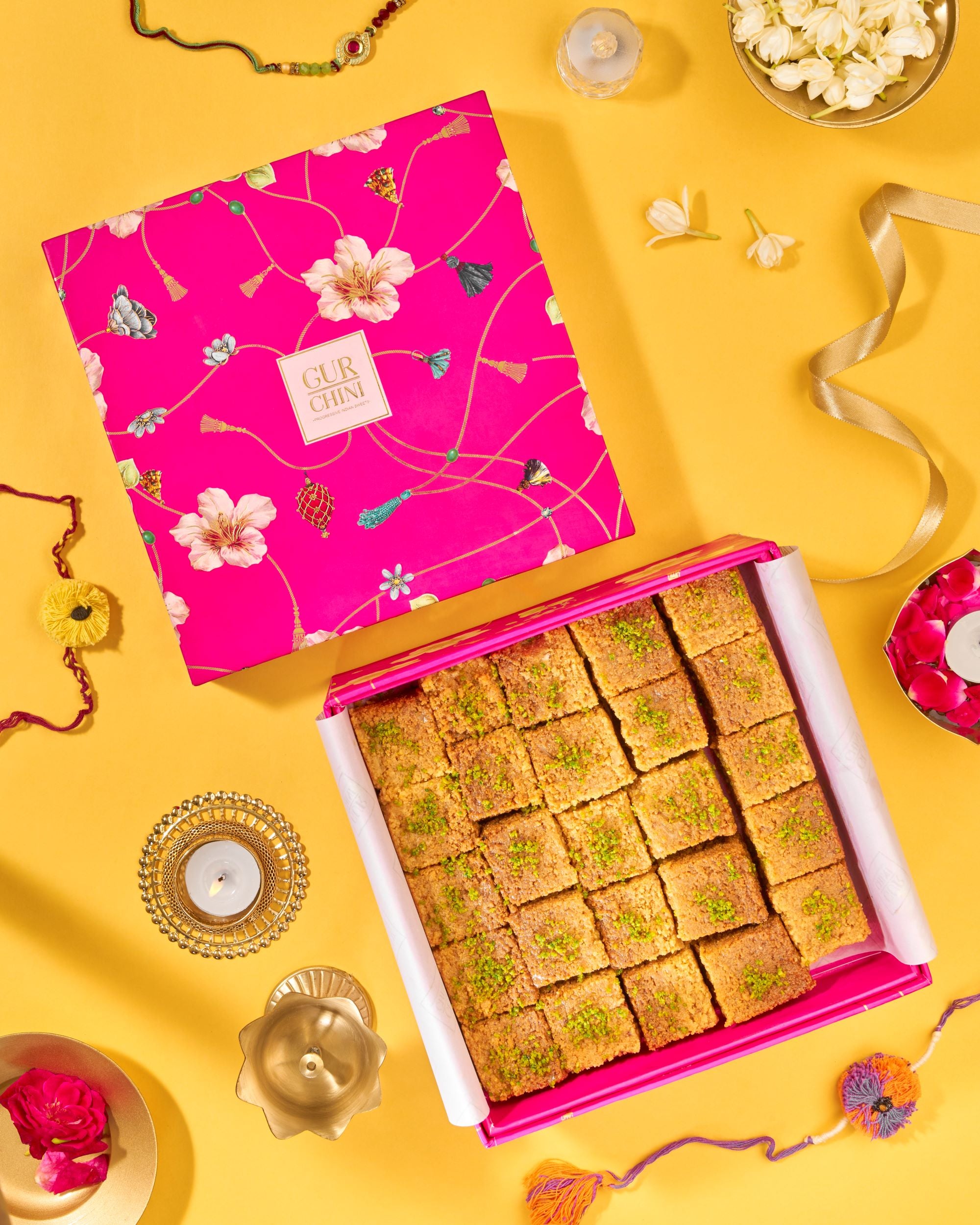 Rakhi Celebration With Luxury Pink Box of Alwar Nolen Gur Milk Cake